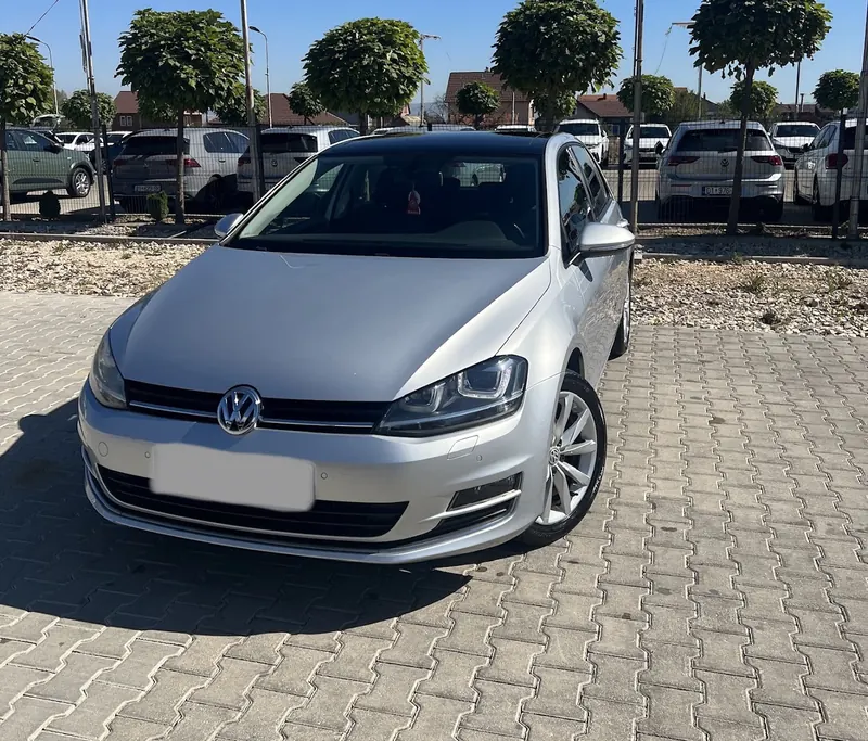 Silver Volkswagen Golf seen from the front on paving stones