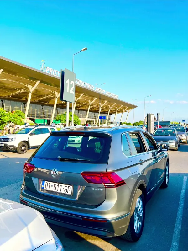 Grey Volkswagen Tiguan 2.0 TDI seen from behind at the Prishtina Airport car park